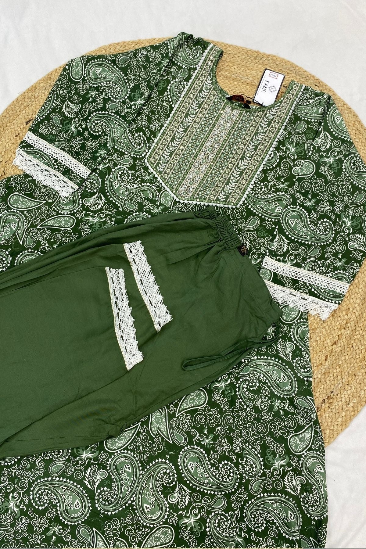 Green and white patterned garment on a textured surface